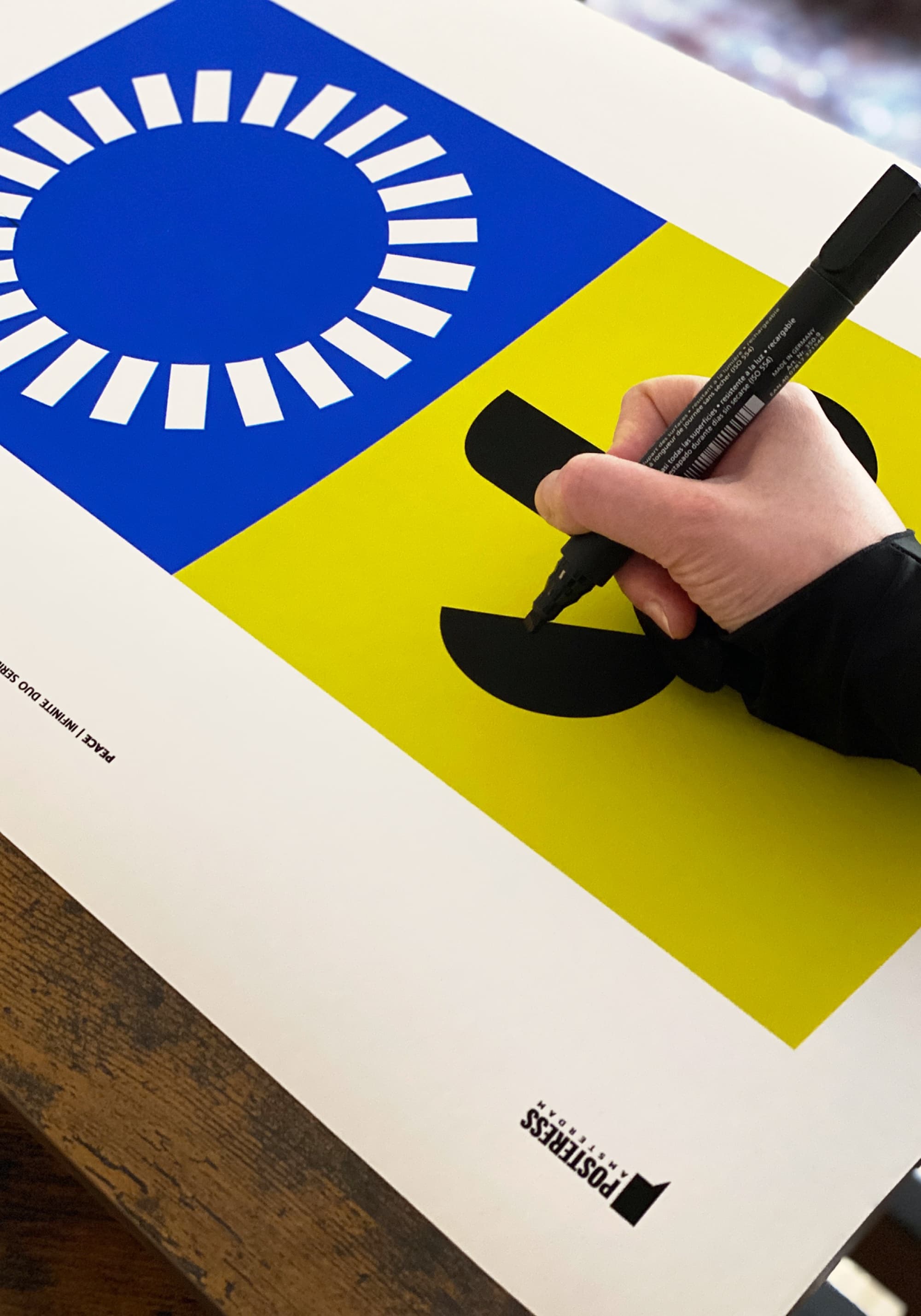 Artist hand-finishing a mixed media poster